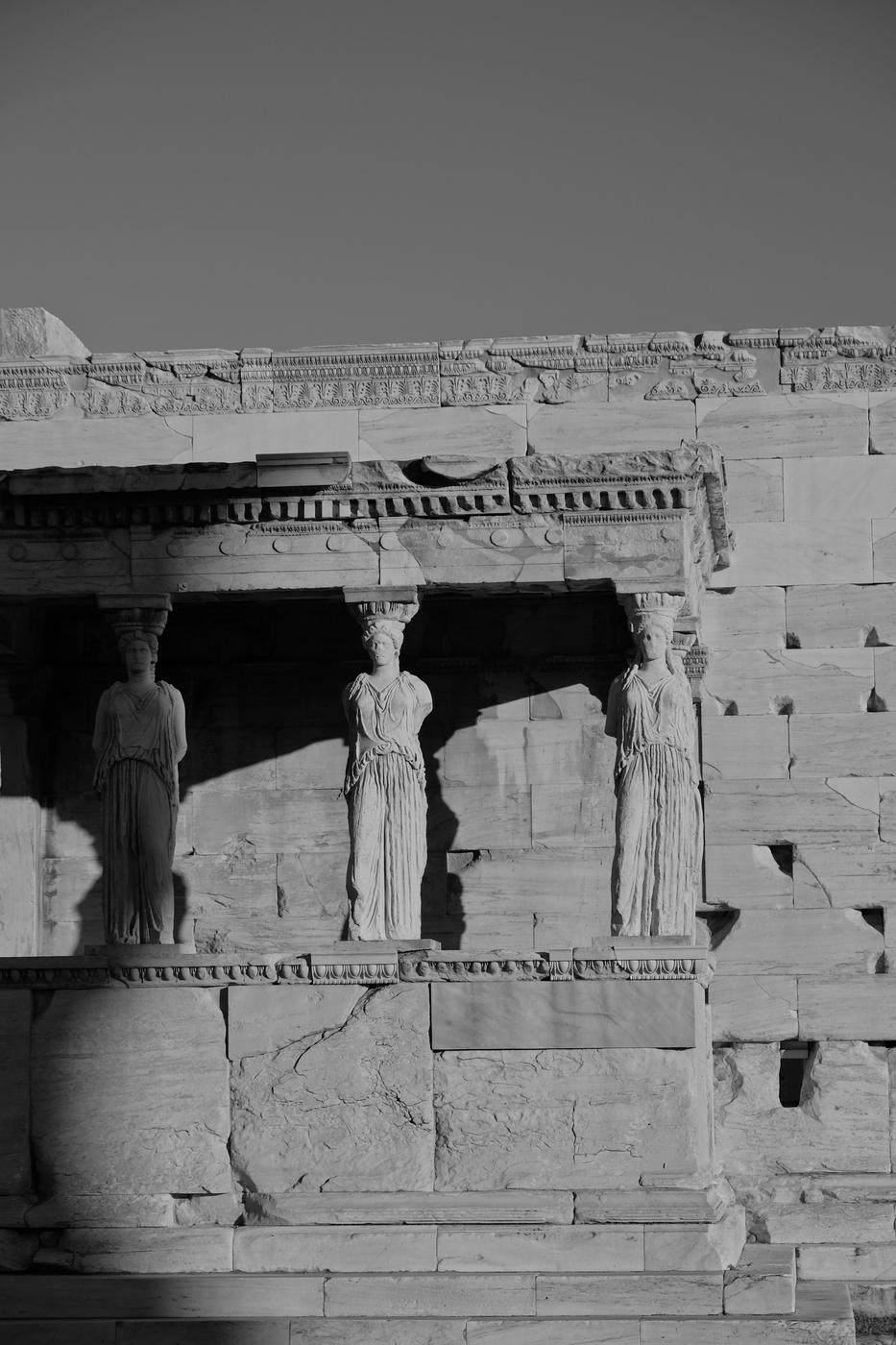 Three caryatids in afternoon light and shadow